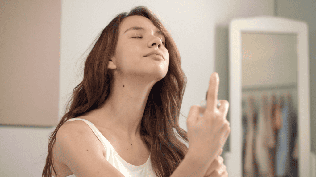 woman applying makeup setting spray.