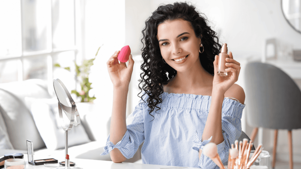 woman applying makeup with sponge. 