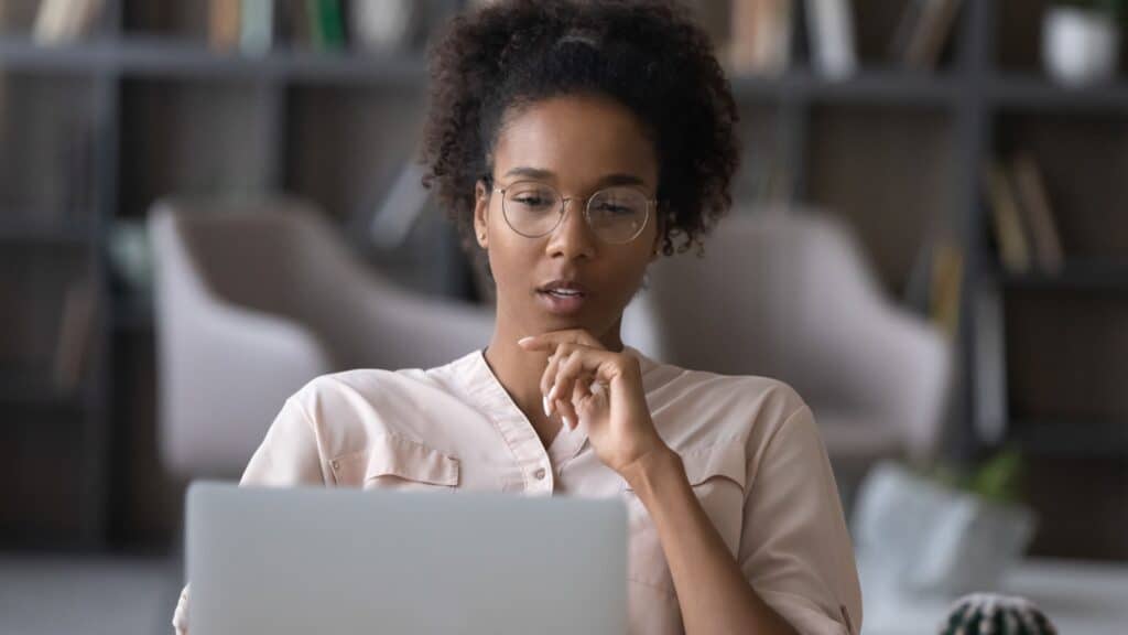 woman upset and critical of information on computer.