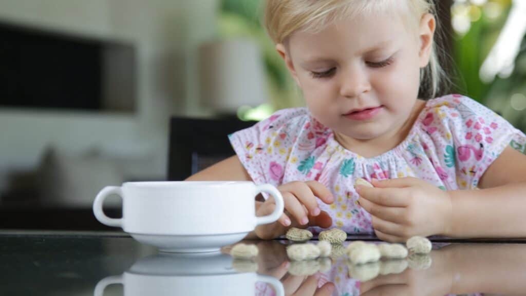 Girl eating peanuts. 