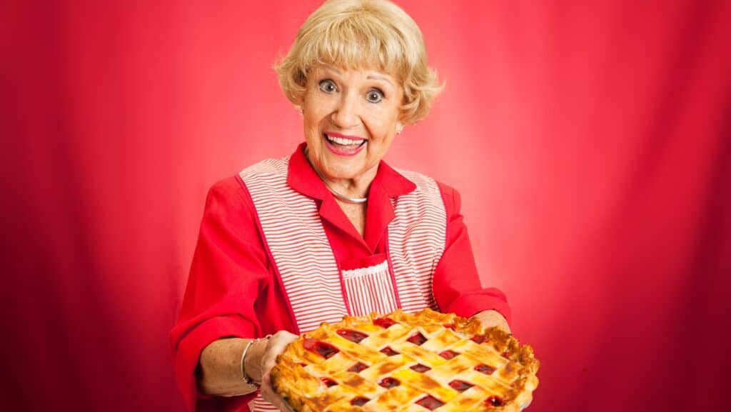 Woman serving pie. 