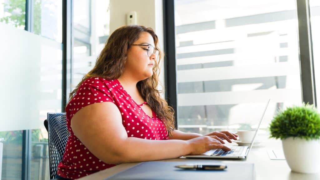 heavy fat woman working. Laptop computer. 