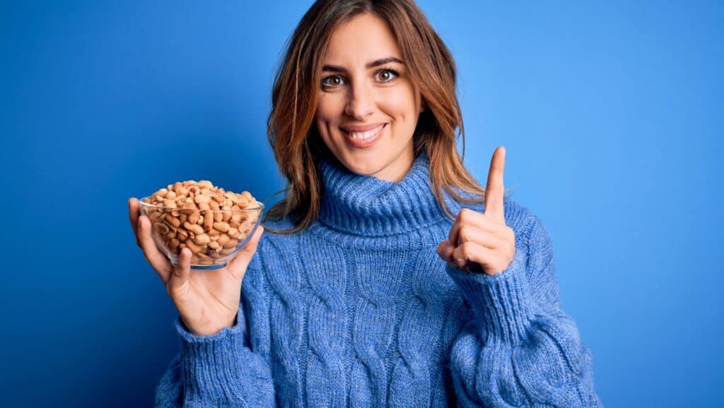 woman eating peanuts. 