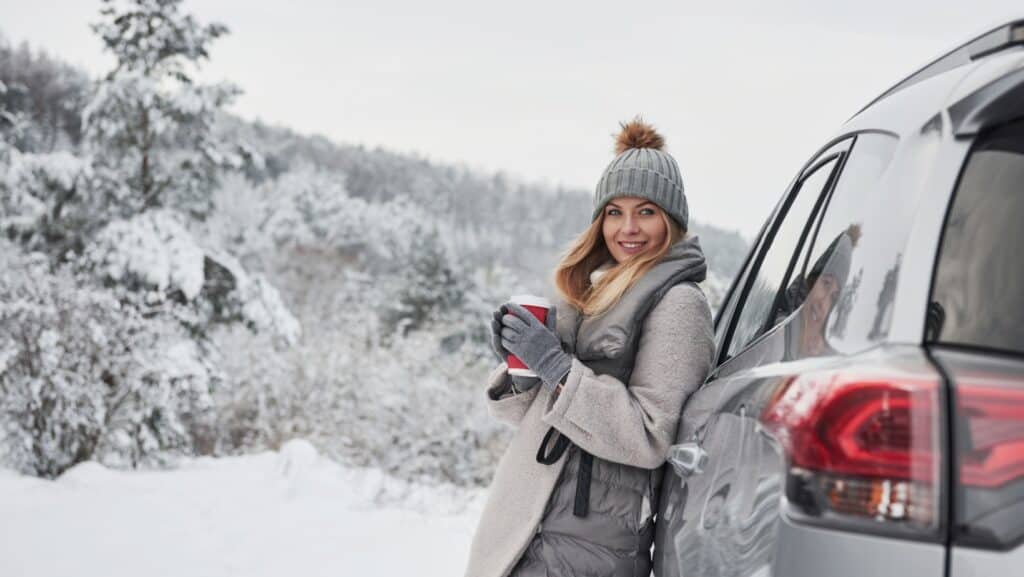 woman with car in winter.