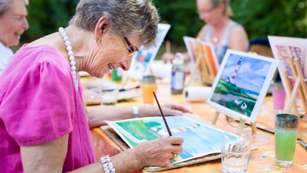 women painting together with friends. 