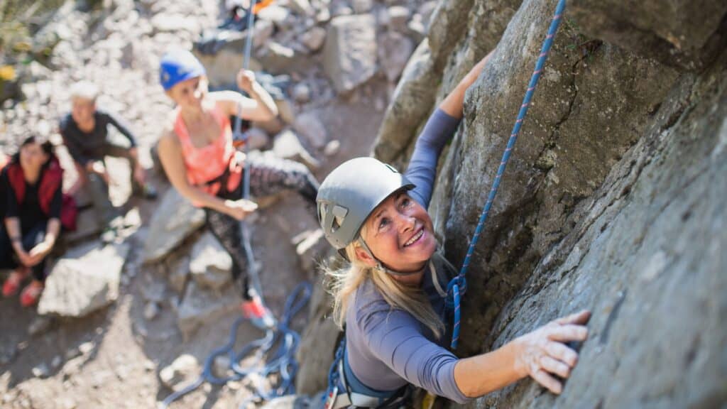 women rock climbing.