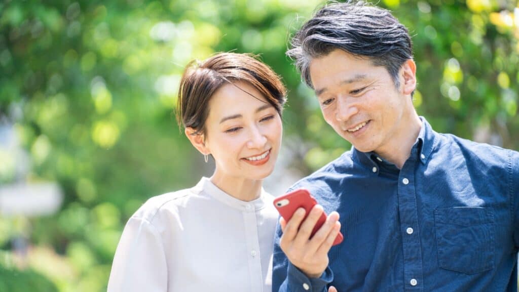 Asian couple using phone. 