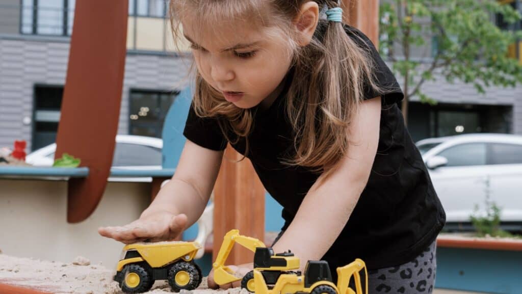 girl playing with trucks.