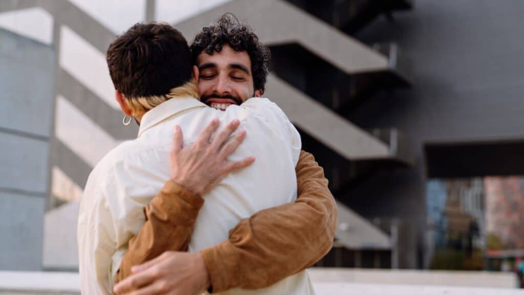 men hugging.