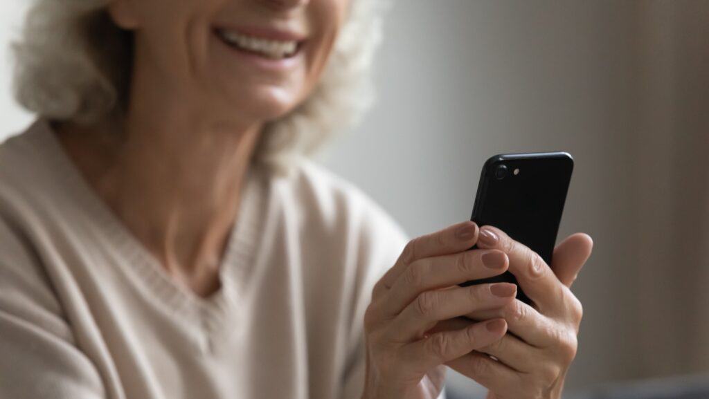 senior older woman using phone.