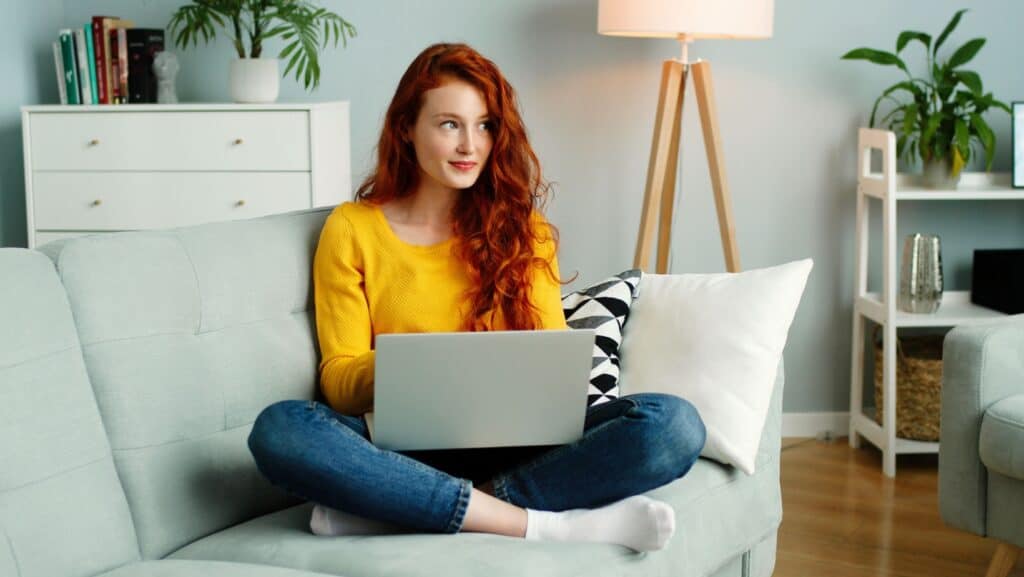 woman with laptop. on couch. 